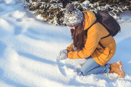 beautiful winter woman playing with snow
