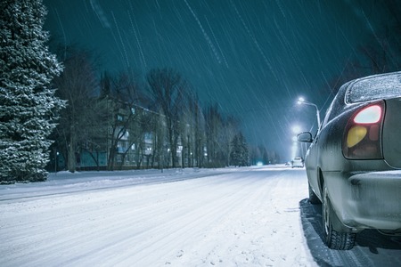 winter night road snow background with car lightsの写真素材