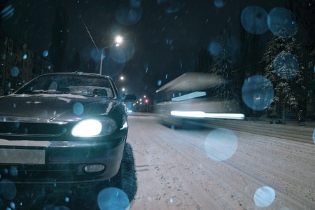 winter night road snow background with car lightsの写真素材