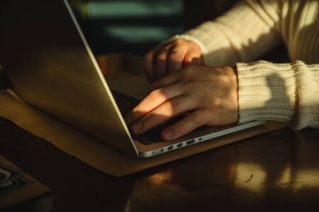 man typing on laptop in caffeの写真素材