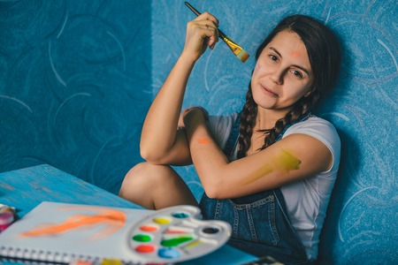 Young pretty holding paint brush. Creativity conceptの写真素材