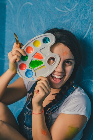 woman fooling around with paintsの写真素材