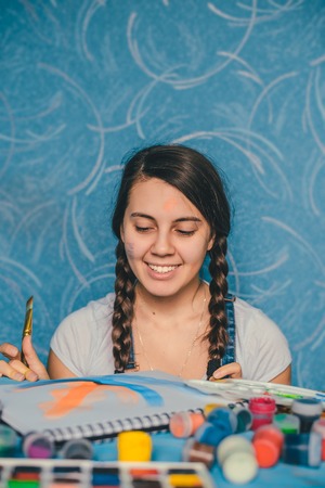 woman fooling around with paintsの写真素材