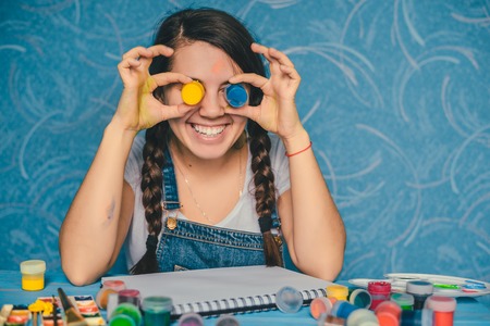 woman fooling around with paintsの写真素材