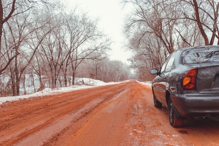lonely car road in snow red because of oreの写真素材