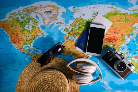 toy car with hat passport and old camera on mapの写真素材