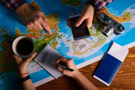 hands point on map where to go travel planing vacation