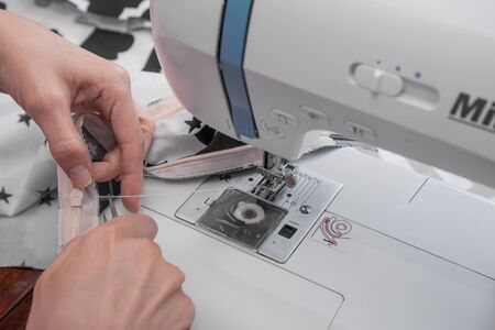 sewing machine and item of clothing close up