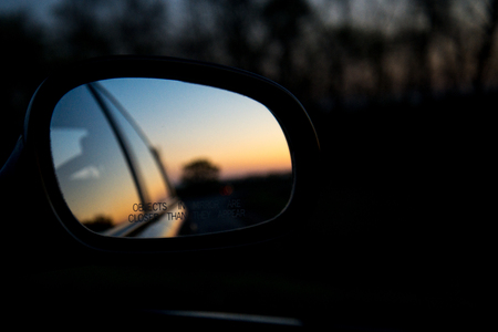 Blue landscape sunset reflect in mirror of carの写真素材