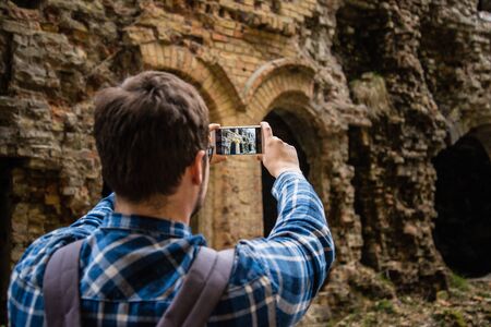 tourist taking picture of ruinsの写真素材