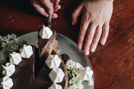 hand cut with knife piece of cakeの写真素材