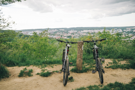 two bicycles stand wth city view on backgroundの写真素材