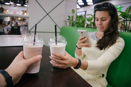 first-person view on woman taking picture of smoothieの写真素材
