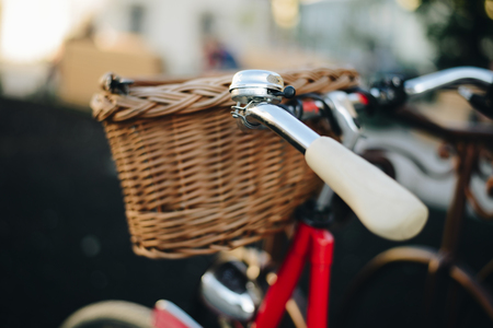 old retro bike with basket in stand on bike park in the cityの写真素材