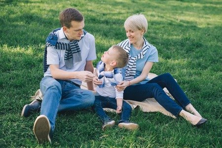 Smiling family sitting on the blanket