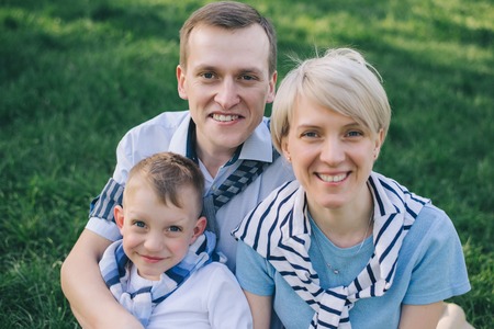 Happy loving family. Mother , father and their son in parkの写真素材