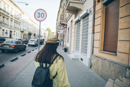 stylish woman walks on old city streetの写真素材
