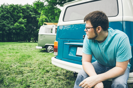 man sits near van and thinks about somethingの写真素材