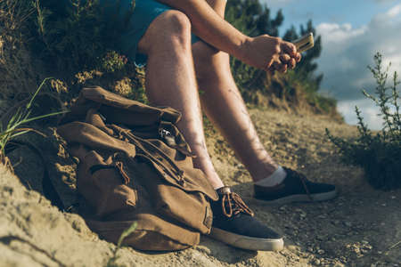 man sits on the ground chating on the phoneの写真素材