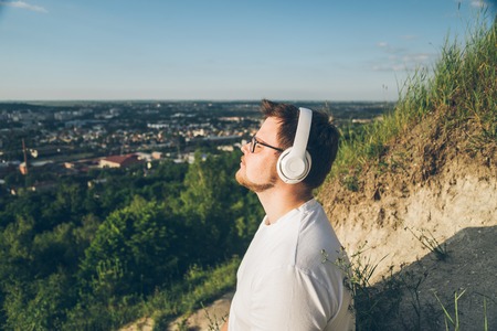 man listen music on the peak of the hillの写真素材