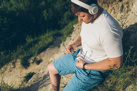 man listen music on the peak of the hillの写真素材