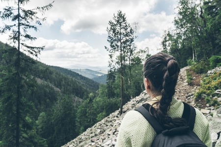 Young lady hiker with backpack walking in carpathianの写真素材