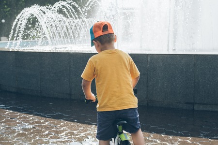 young boy riding strider bikeの写真素材