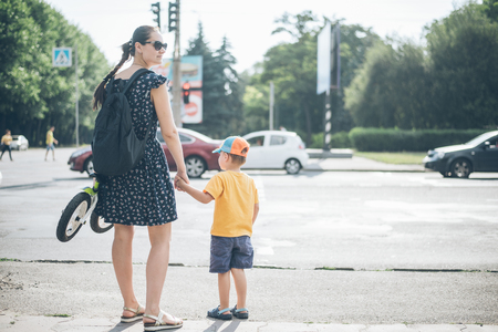 mother with son stands on traffic lightの写真素材