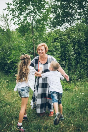 Grandmother playing in the park with grandchildren