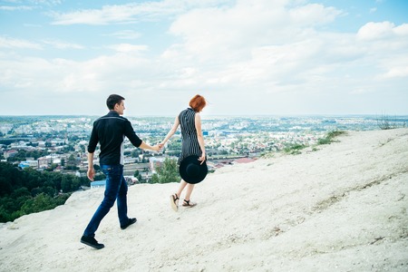 Man walking with woman on the top of the hill