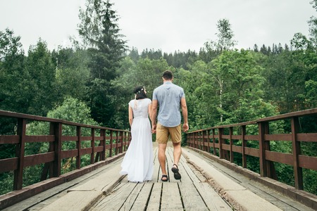 man with woman walking on the bridgeの写真素材