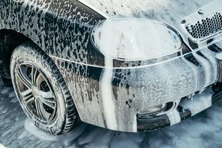 car in foam on carwashの写真素材