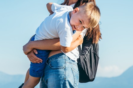 woman playing with her kid on the peak of the mountainの写真素材