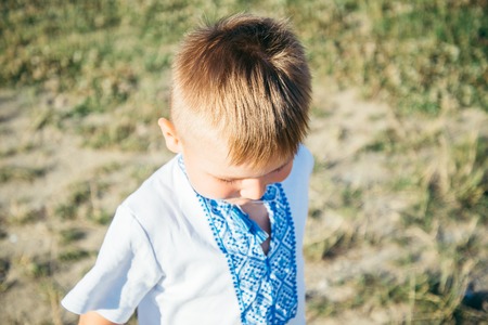 little boy playing on the top of the mountainの写真素材
