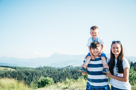 father and little son on his shoulders , motherの写真素材