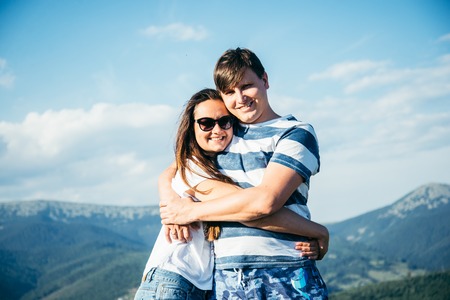 Loving young couple on a mountain, huggingの写真素材