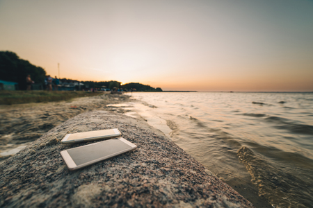 two mobiles phone on the rockの写真素材