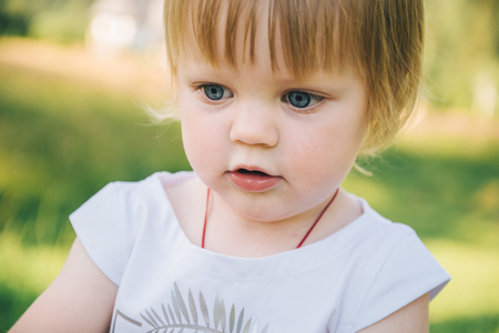 Baby girl spending time outdoor on a summer day.の写真素材