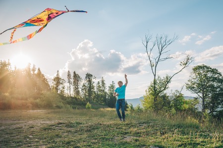 man plays with Kite in the skyの写真素材
