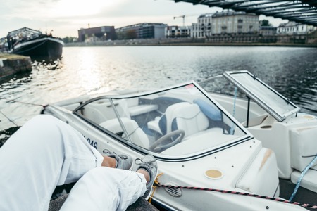 woman sits on piar looking on the riverの写真素材