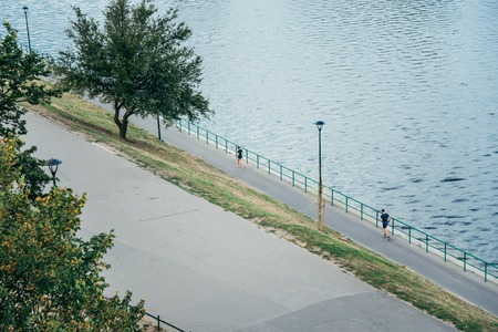 runners on the riverside in the morningの写真素材