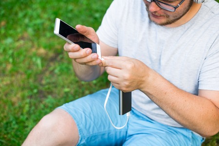 mant connect power bank to his phoneの写真素材