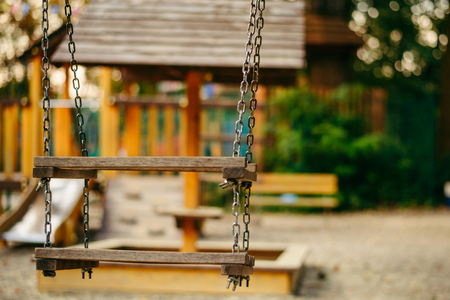Empty chain swings on playground in the public parkの写真素材