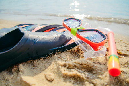 Mask with snorkel and flippers on the beachの写真素材