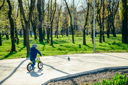 young boy riding strider bikeの写真素材
