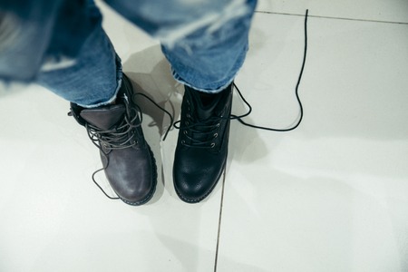 woman choosing new boots in the shopの写真素材