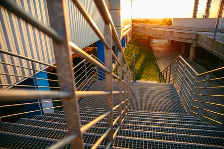 man sitting on stairs and looking on sunsetの写真素材