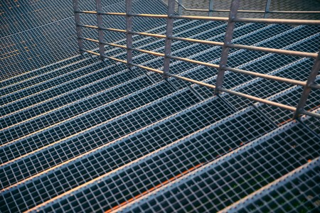 man sitting on stairs and looking on sunsetの写真素材