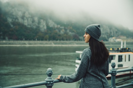 woman at city dock in foggy dayの写真素材