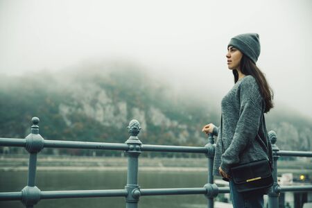 woman at city dock in foggy dayの写真素材